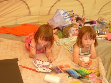 Amelie and Charlotte chill out in the craft tent with their Oliver Bears