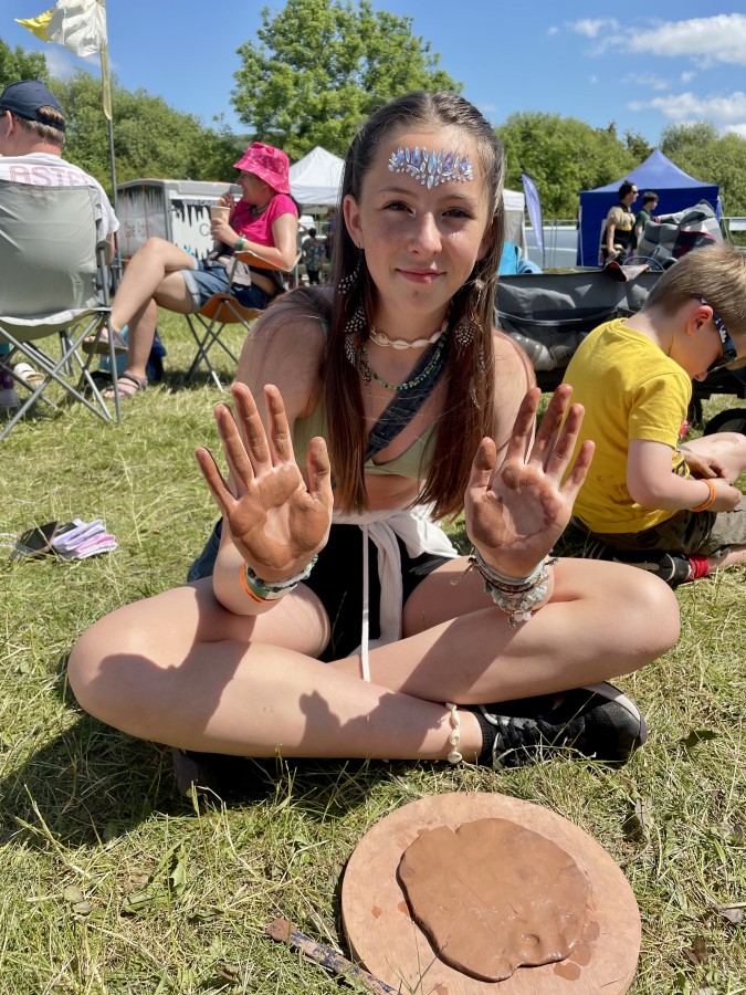 Girl with muddy clay hands